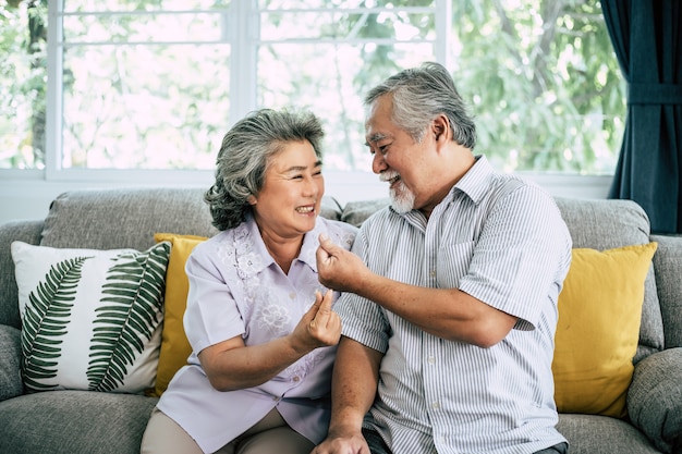 Senior couple playing together at living room