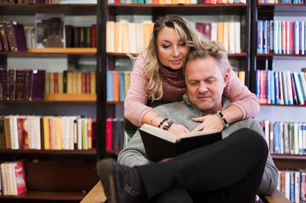 Senior couple reading book together