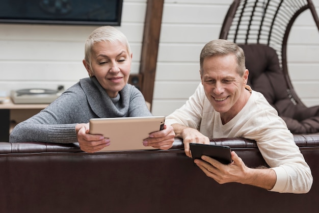 Senior couple spending time together on their devices