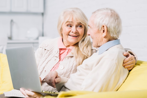 Senior couple using laptop