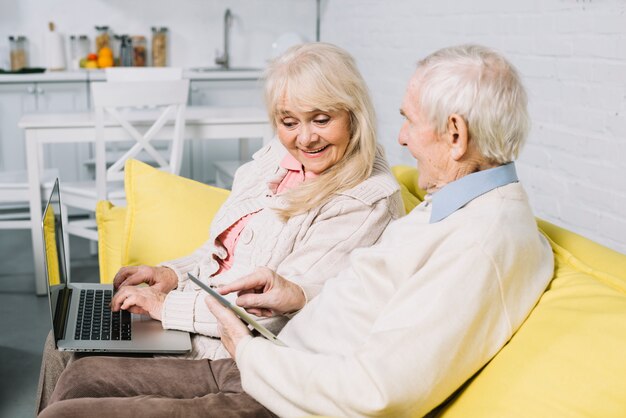 Senior couple using laptop