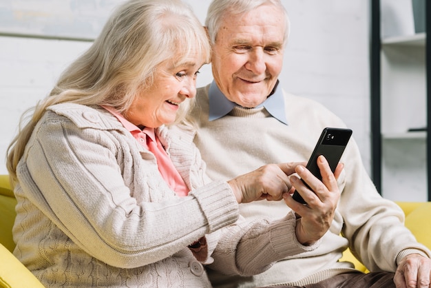 Senior couple using smartphone