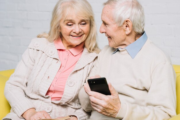 Senior couple using smartphone