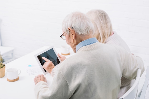 Senior couple using tablet