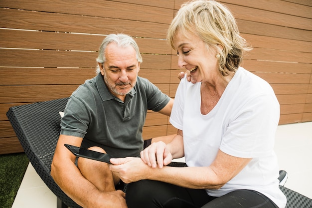 Free photo senior couple with smartphone in garden