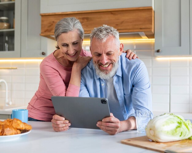 Senior couple with tablet medium shot