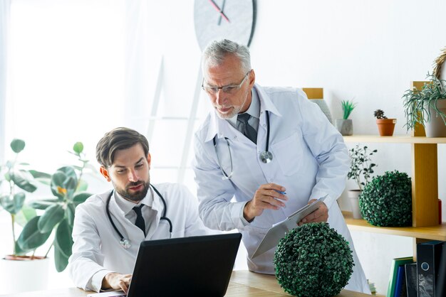 Senior doctor checking work of colleague