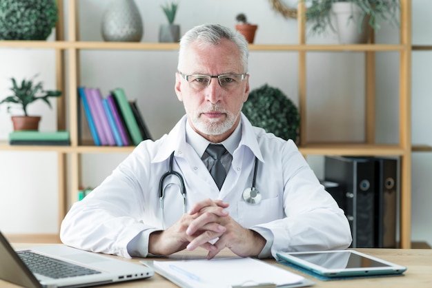 Senior doctor sitting in office