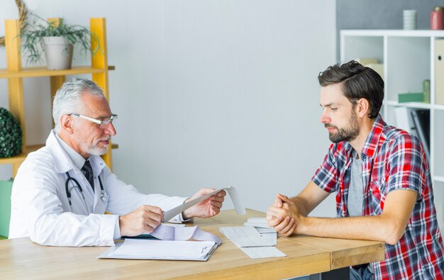 Senior doctor talking with patient