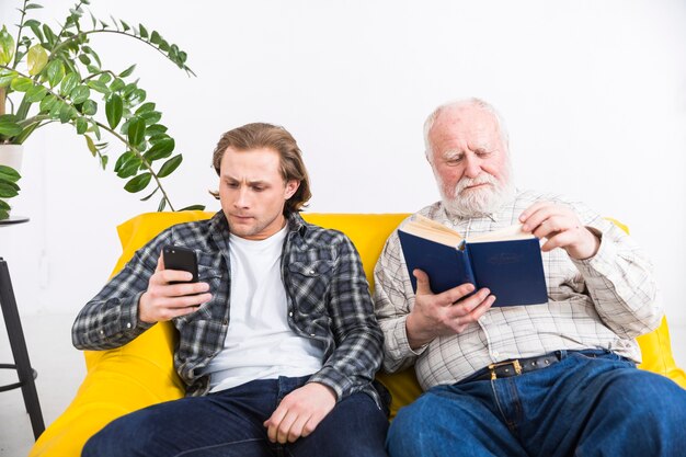 Senior Father and adult son relaxing separate