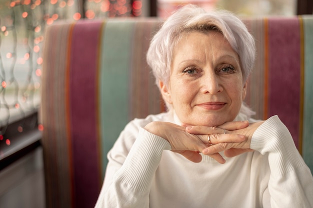 Senior female at restaurant sitting