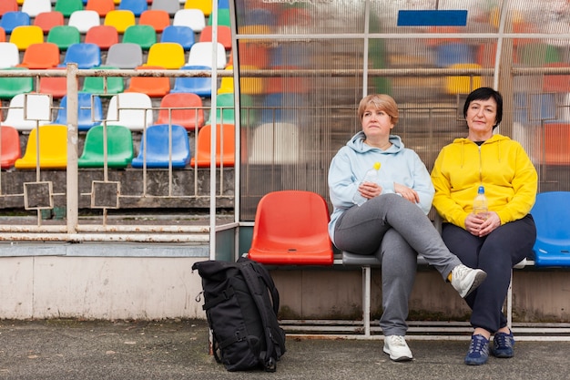 Free photo senior females on stadium resting