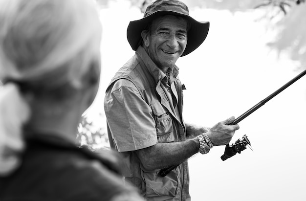 Senior friends fishing by the lake