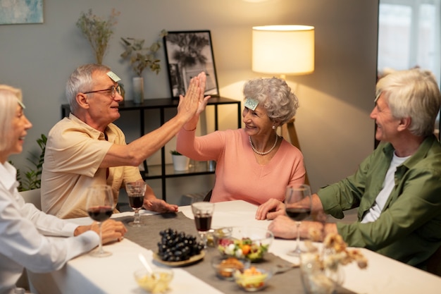 Free photo senior friends having a party at night