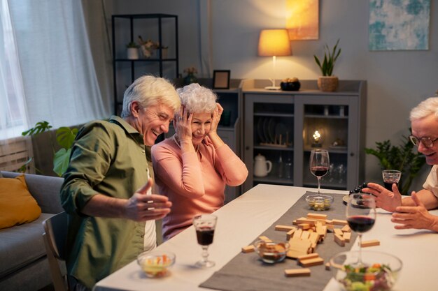 Senior friends having a party at night