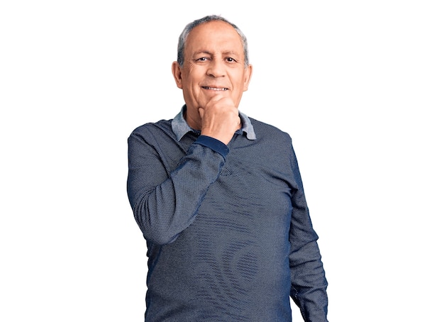 Senior handsome man wearing casual polo looking confident at the camera with smile with crossed arms and hand raised on chin. thinking positive.