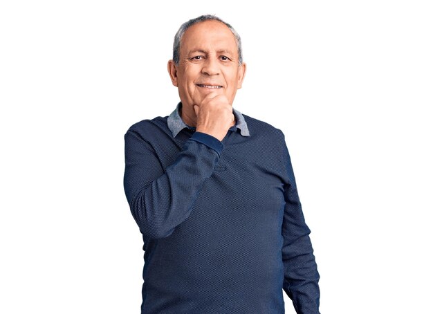 Senior handsome man wearing casual polo looking confident at the camera with smile with crossed arms and hand raised on chin. thinking positive.