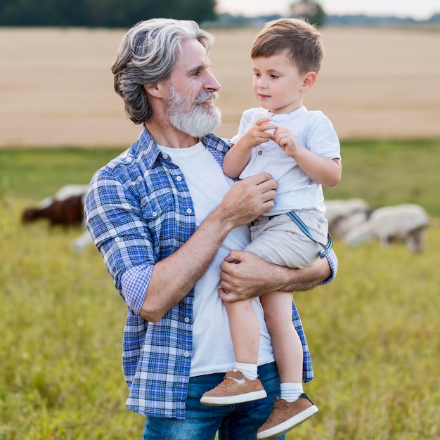 Senior holding little boy