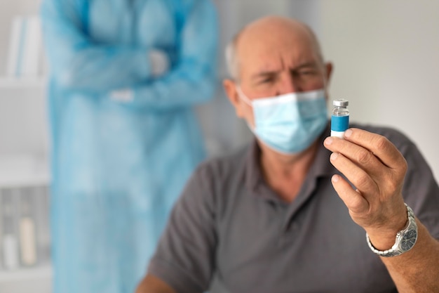 Senior male patient getting vaccinated for coronavirus