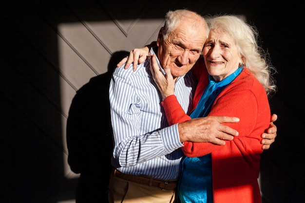 Senior male and woman hugging