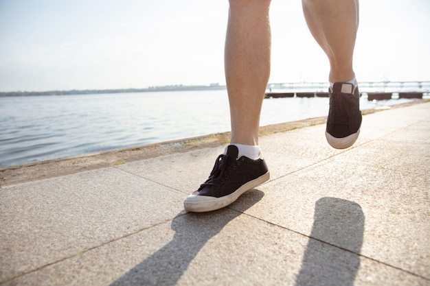 Senior man as runner with armband or fitness tracker at the riverside