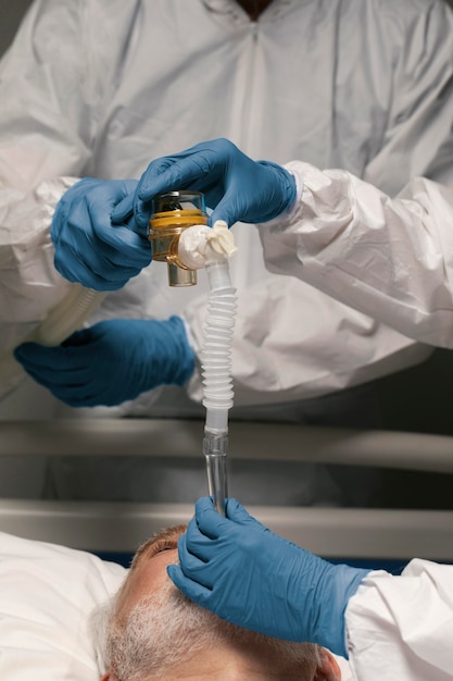 Senior man breathing with a special equipment