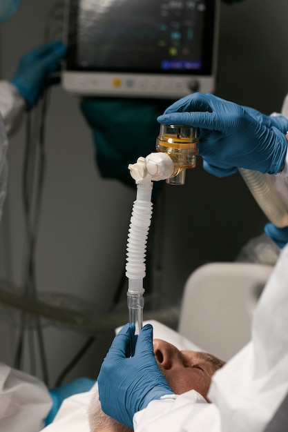 Senior man breathing with a special equipment