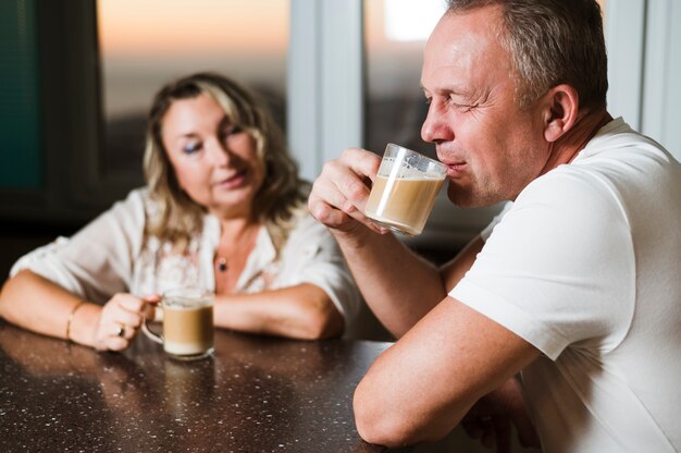 Senior man drinking coffee with wife