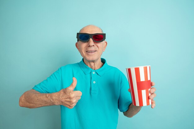 Senior man gives thumb up at the cinema