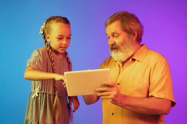 Senior man, grandfather having fun and spending time together with granddaughter.