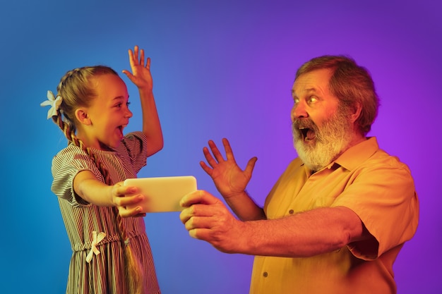 Free photo senior man, grandfather having fun and spending time together with granddaughter.