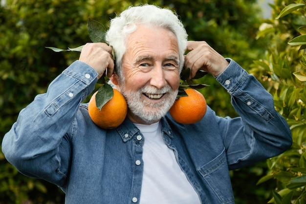 Senior man harvesting orange trees