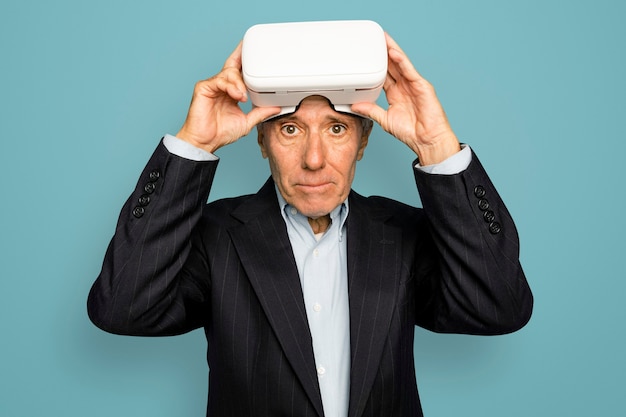 Senior man having wearing VR headset digital device