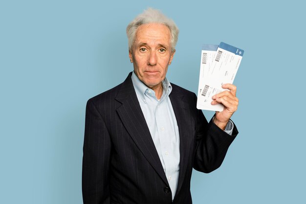 Senior man in holding plane tickets for business trip