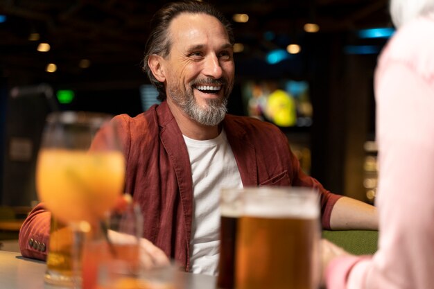 Senior man laughing at a restaurant