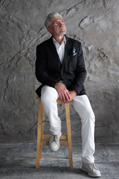 Senior man looking elegant and posing in suit