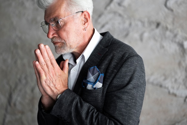 Senior man looking elegant and posing in suit