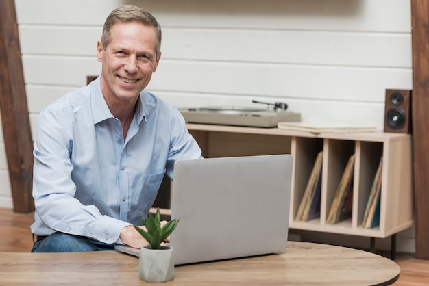 Senior man looking through the internet on his laptop