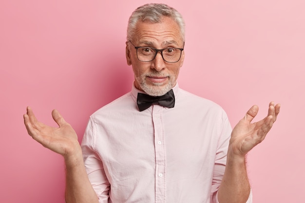 Senior man in pink shirt and black bowtie