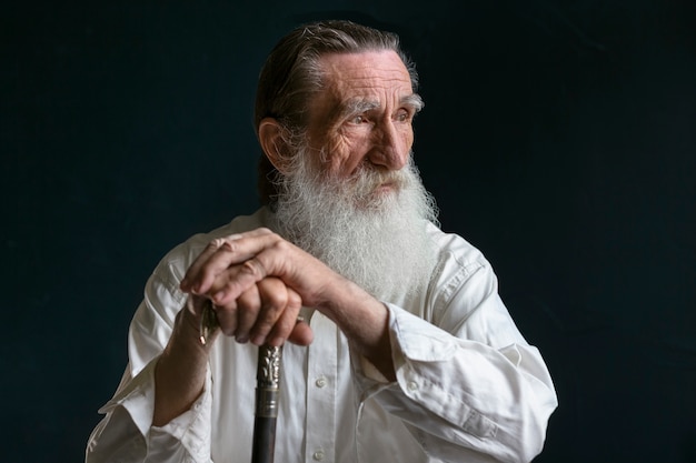 Free photo senior man posing indoors front view