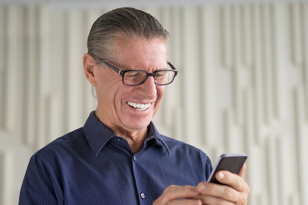 Senior Man Reading Text Message on Phone