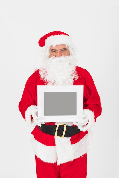 Senior man in Santa Claus costume holding empty frame 