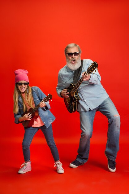 Senior man spending happy time with granddaughter in neon.