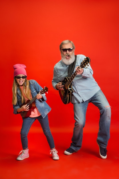 Senior man spending happy time with granddaughter in neon.