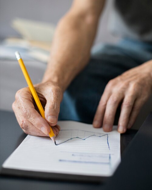 Senior man taking notes in class