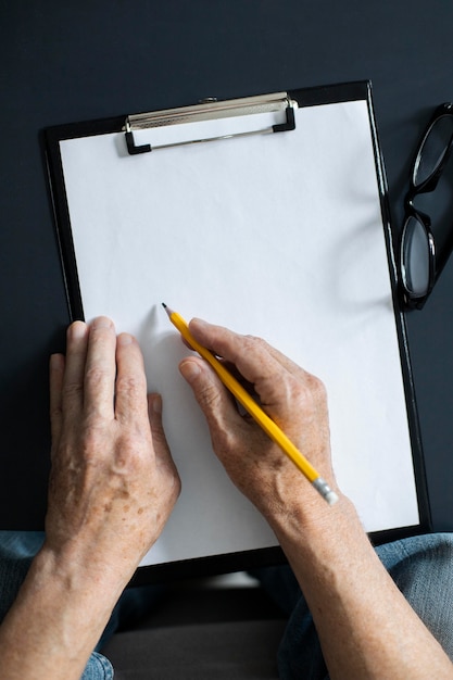 Free photo senior man taking notes in class