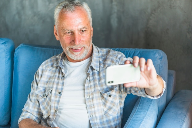 Free photo senior man taking self portrait