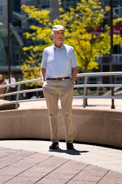 Free photo senior man taking a walk outdoors in the city