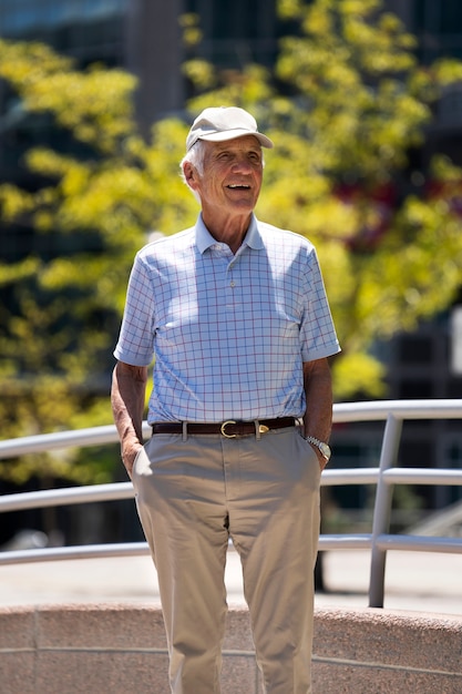 Free photo senior man taking a walk outdoors in the city