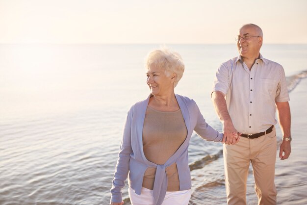 Free photo senior man walking behind his wife